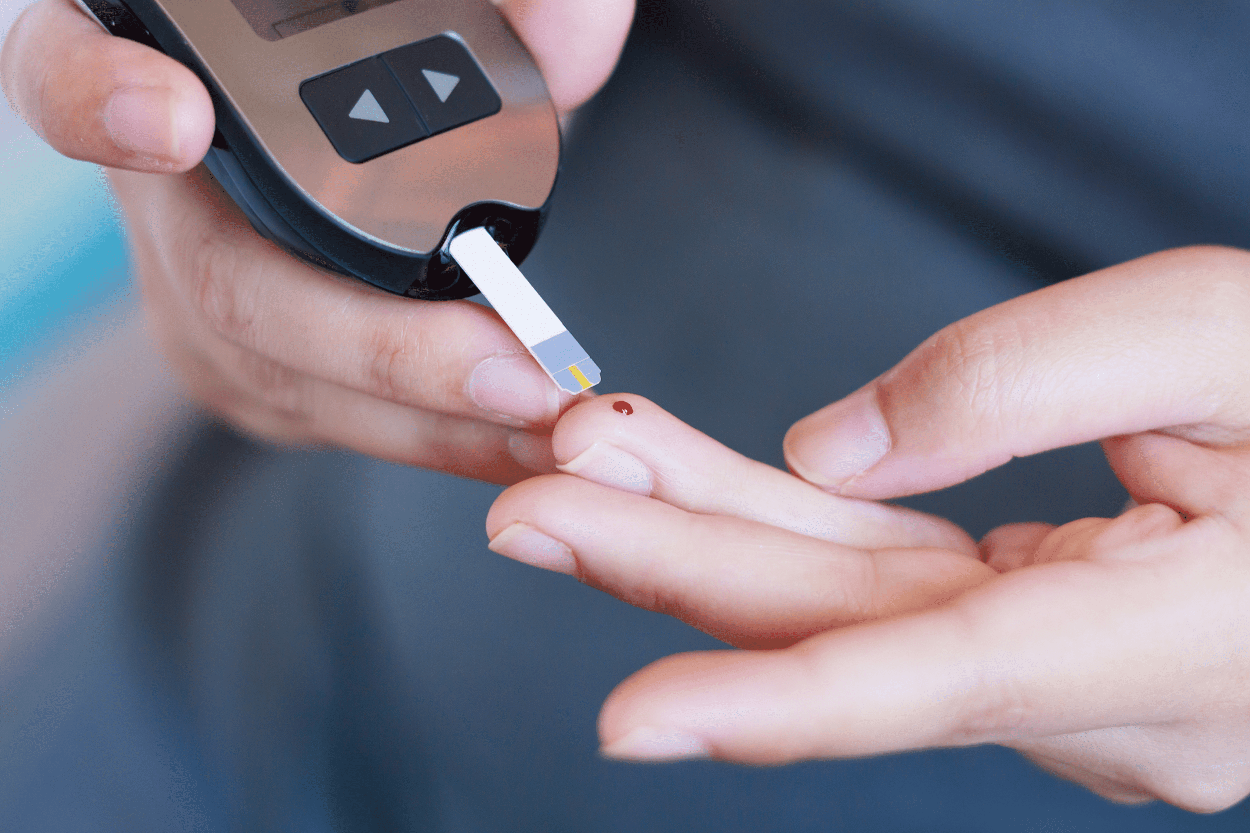 patient performing diabetes test on finger