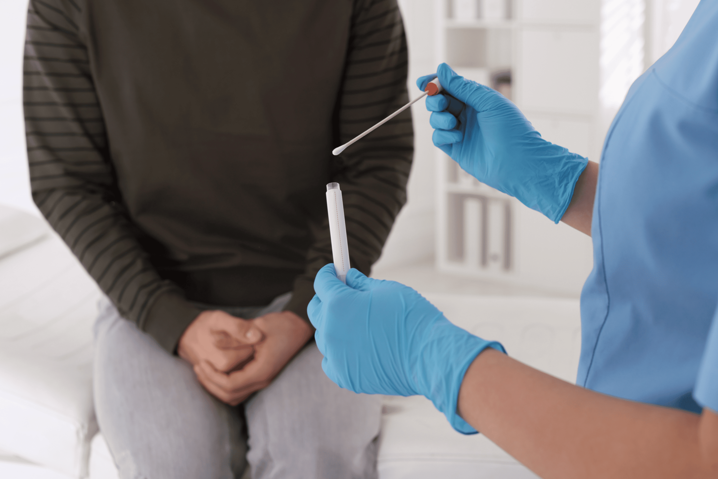 medical professional holding swab about to perform STD test